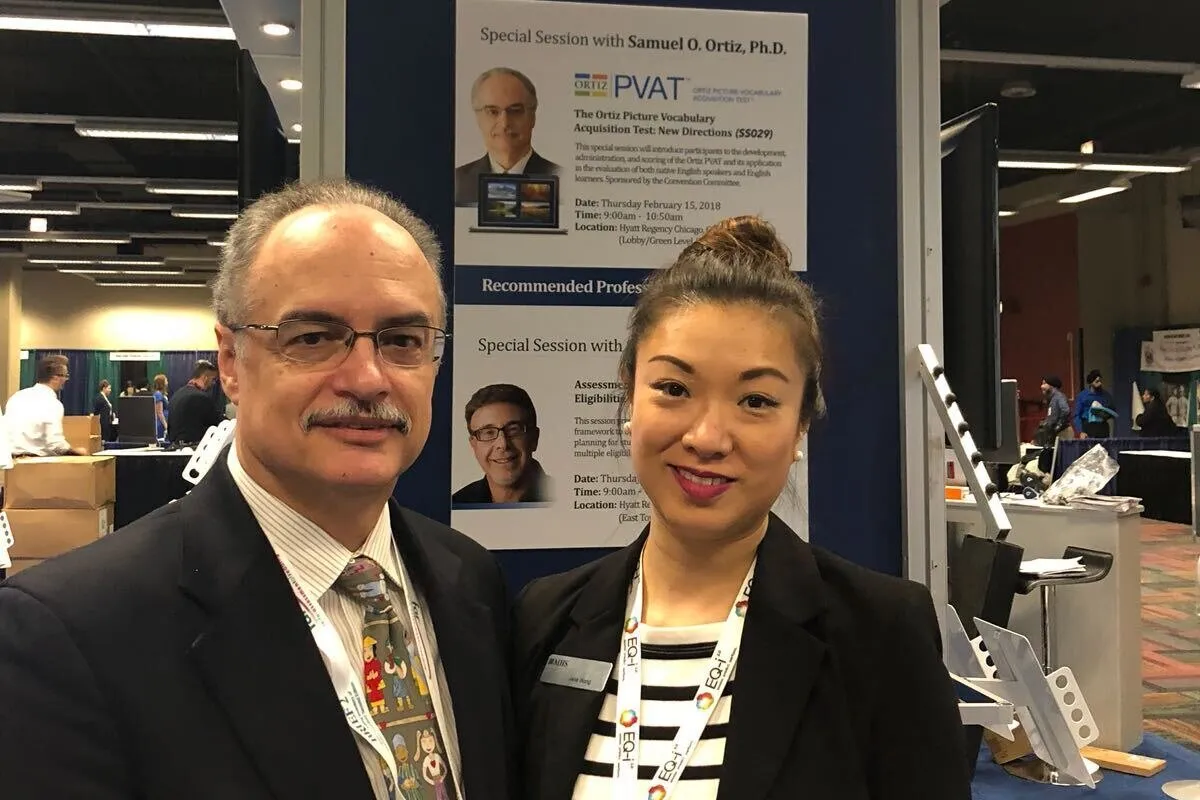 Dr. Ortiz and Jane Wong in front of a conference poster announcing a special session on the Ortiz PVAT.